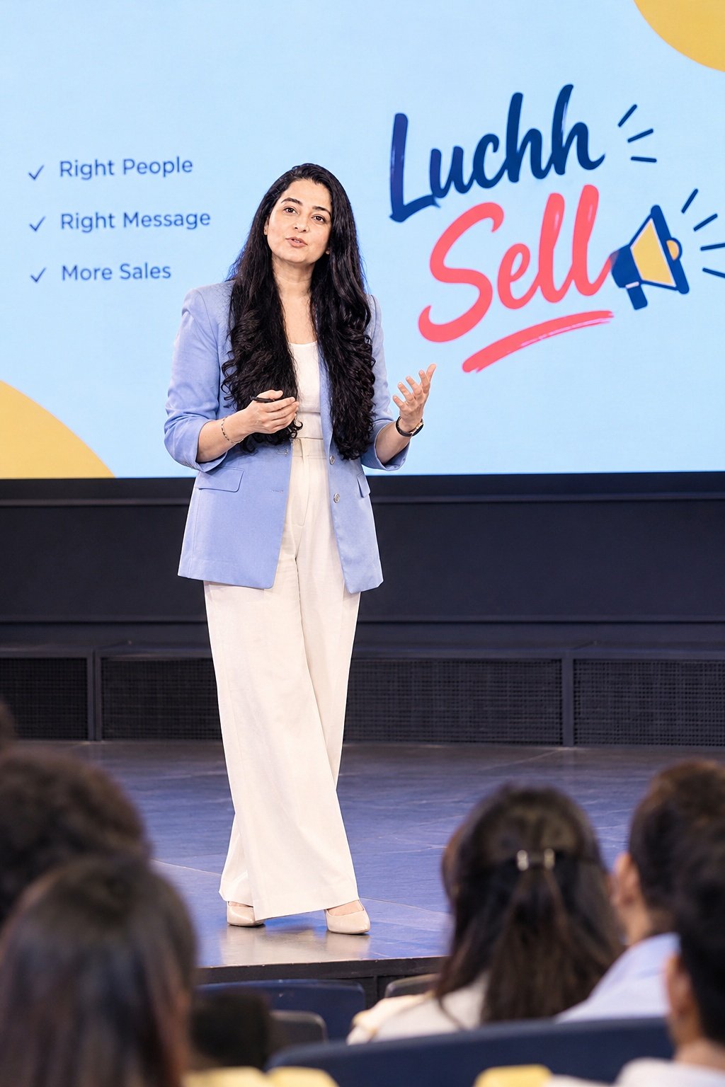 Dr. Mansi Sehdev presenting on stage to an audience